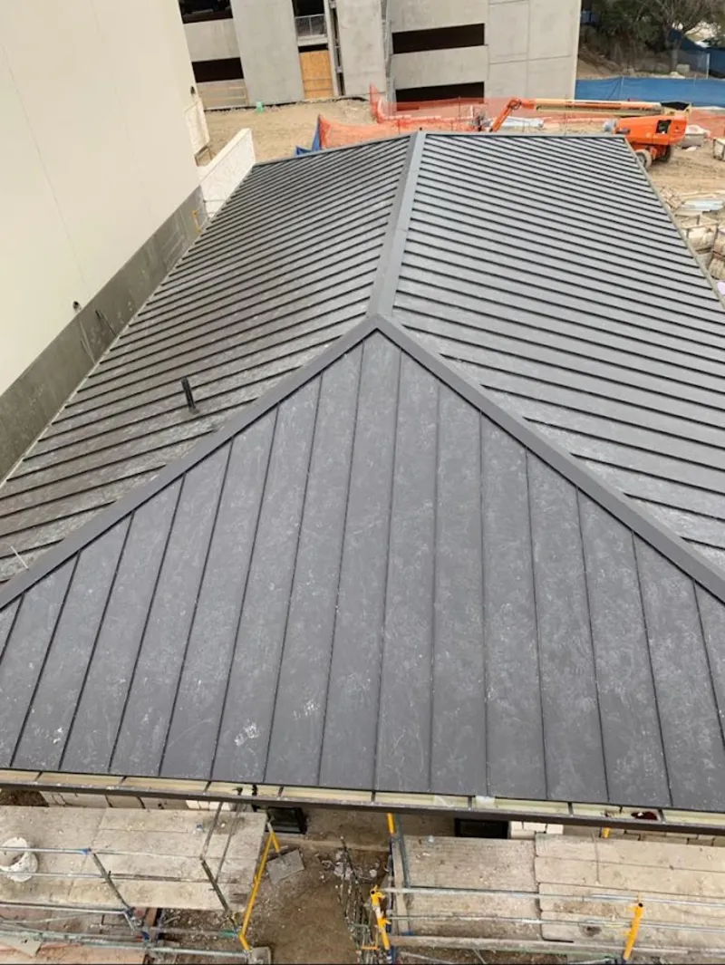 Commercial metal roof construction with crane equipment in Torrance